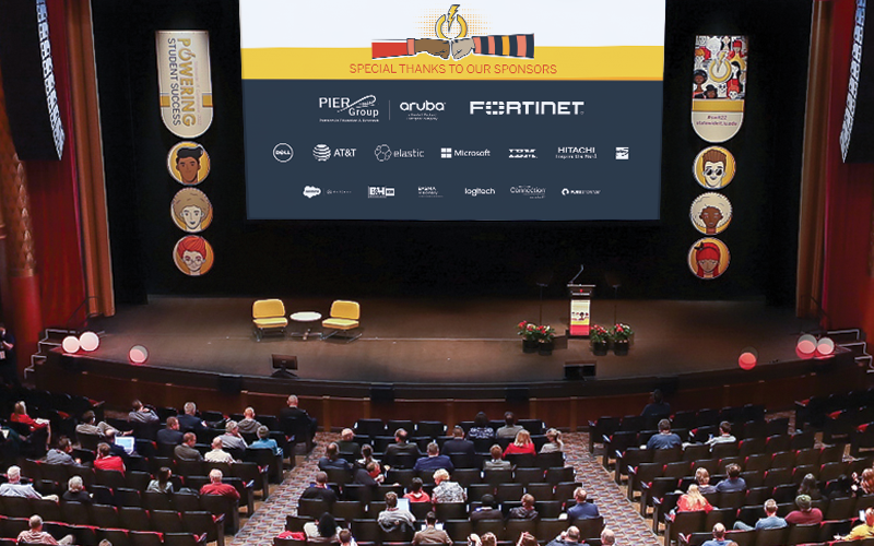 View of the IU Auditorium stage with sponsor logos displayed on the screen during the annual Statewide IT conference